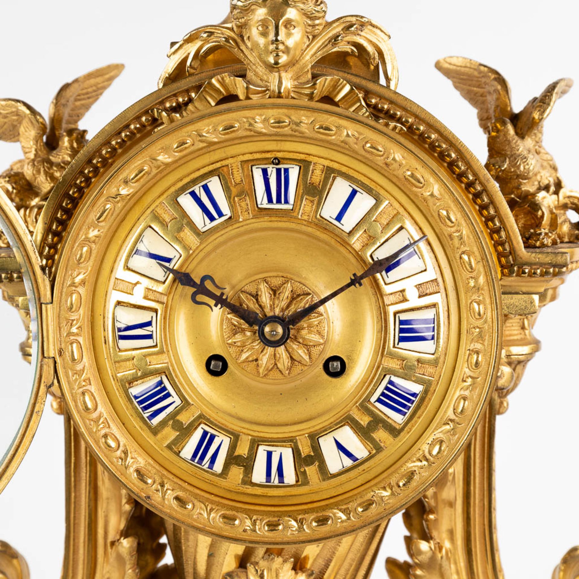 A three-piece mantle garniture clock and candelabra, gilt bronze in a Louis XVI style, 19th C. (D:19 - Image 17 of 19