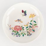 A Chinese saucer, decor of flowers and butterflies. 18th C. (D:15,5 x H:3 cm)
