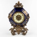 A mantle clock, glazed ceramics and mounted with patinated bronze. 19th C. (D:11 x W:26 x H:38 cm)