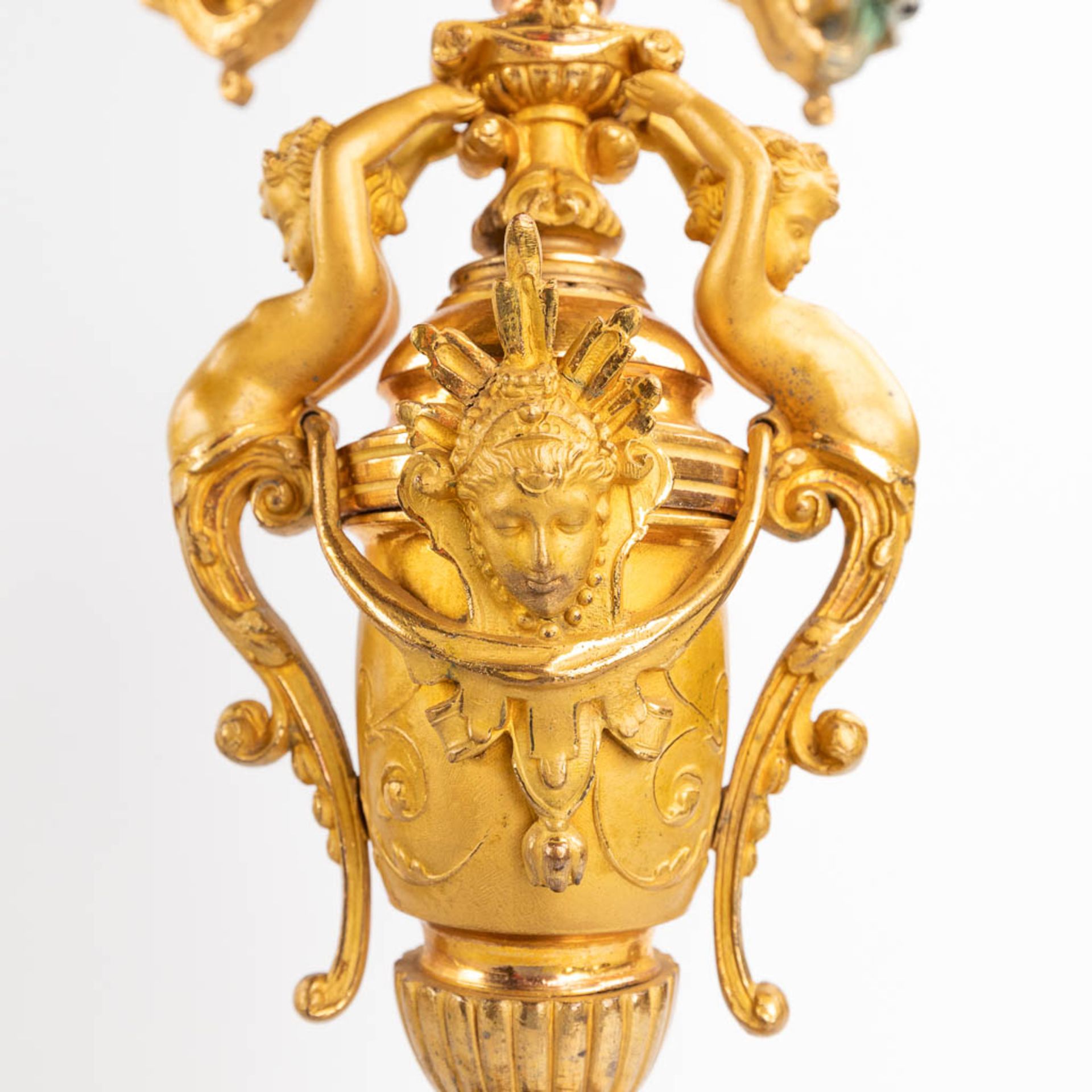 A three-piece mantle garniture clock and candelabra, gilt spelter, decorated with putti. Circa 1900. - Image 11 of 19