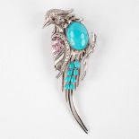 A brooch in the shape of a bird, 14kt white gold with Turquoise, Ruby and brilliant cut diamonds. 21
