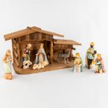 Hummel, A 12-piece Nativity scène in a wood house. (H:20 cm)