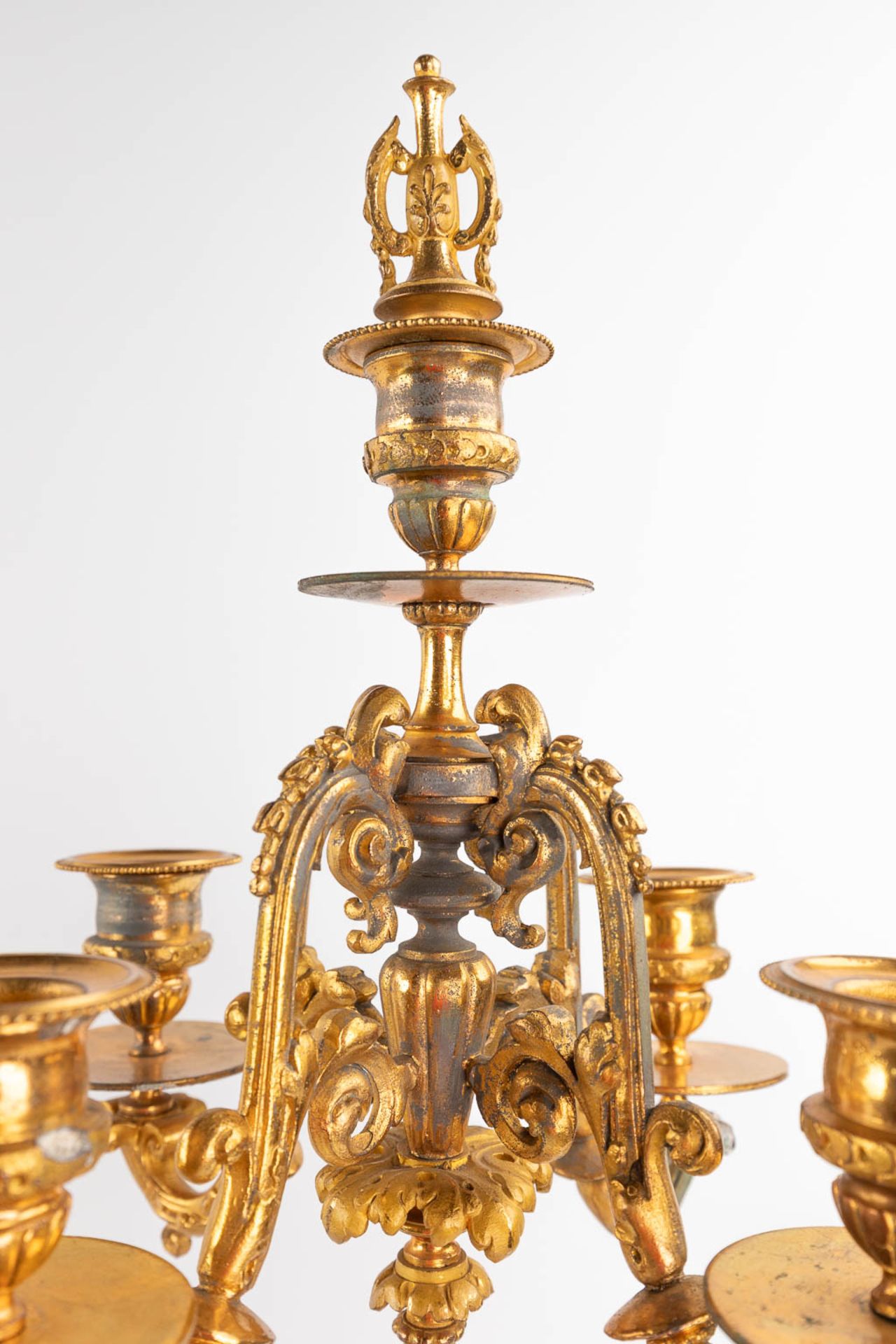 A three-piece mantle garniture clock and candelabra, gilt spelter, decorated with putti. Circa 1900. - Image 9 of 19