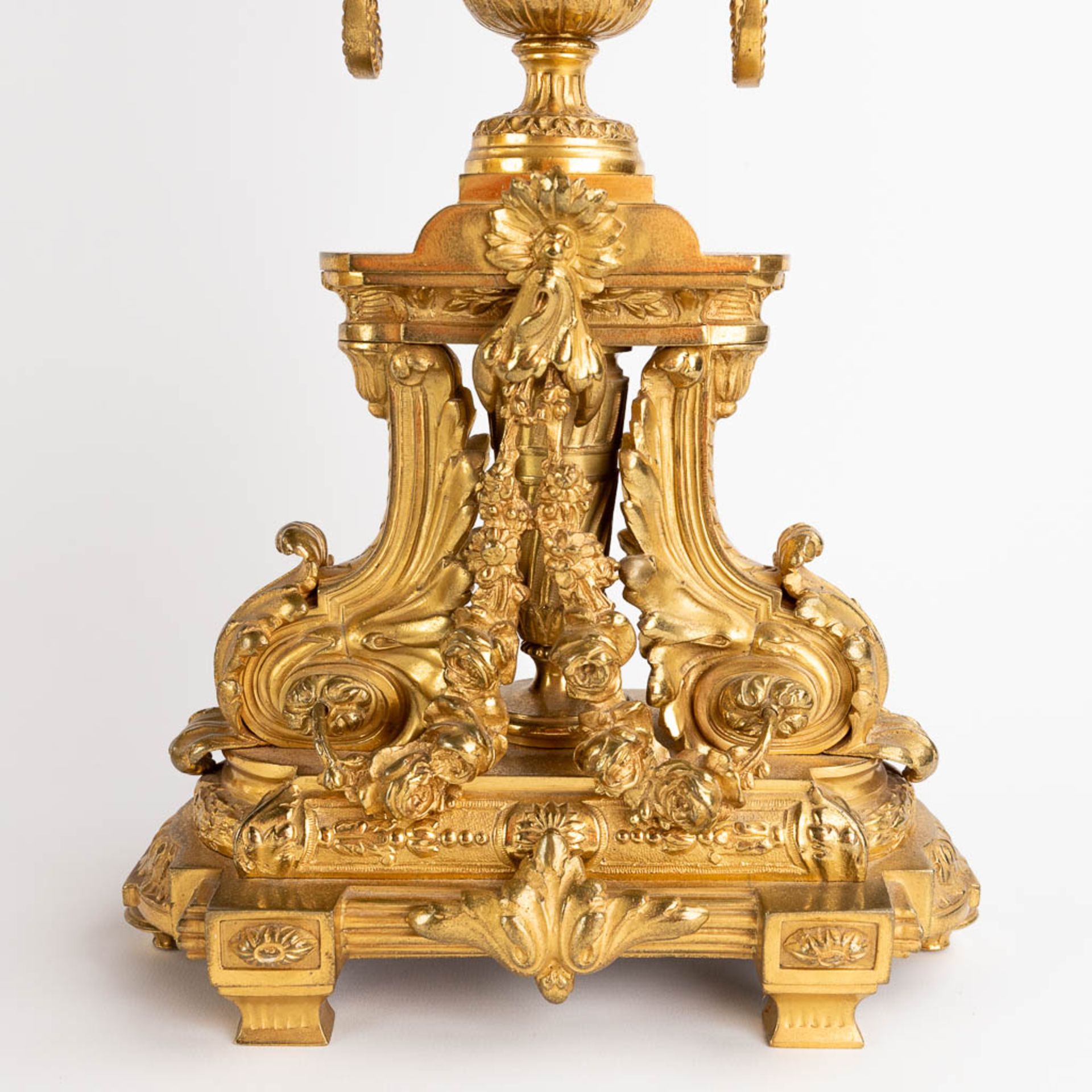 A three-piece mantle garniture clock and candelabra, gilt bronze in a Louis XVI style, 19th C. (D:19 - Image 11 of 19