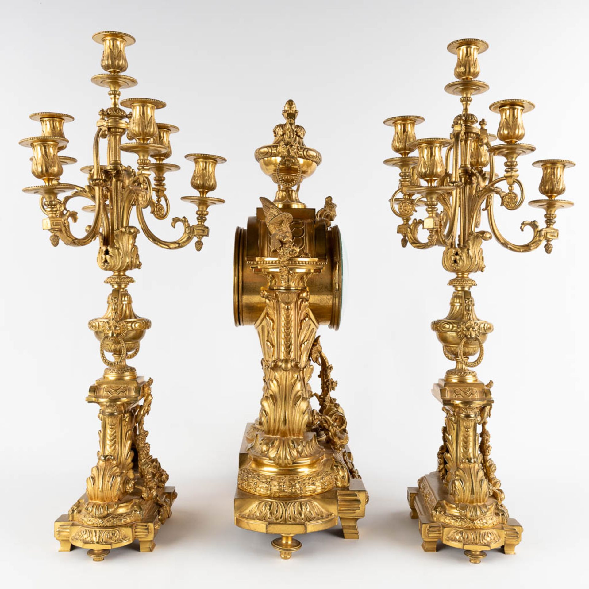 A three-piece mantle garniture clock and candelabra, gilt bronze in a Louis XVI style, 19th C. (D:19 - Image 4 of 19