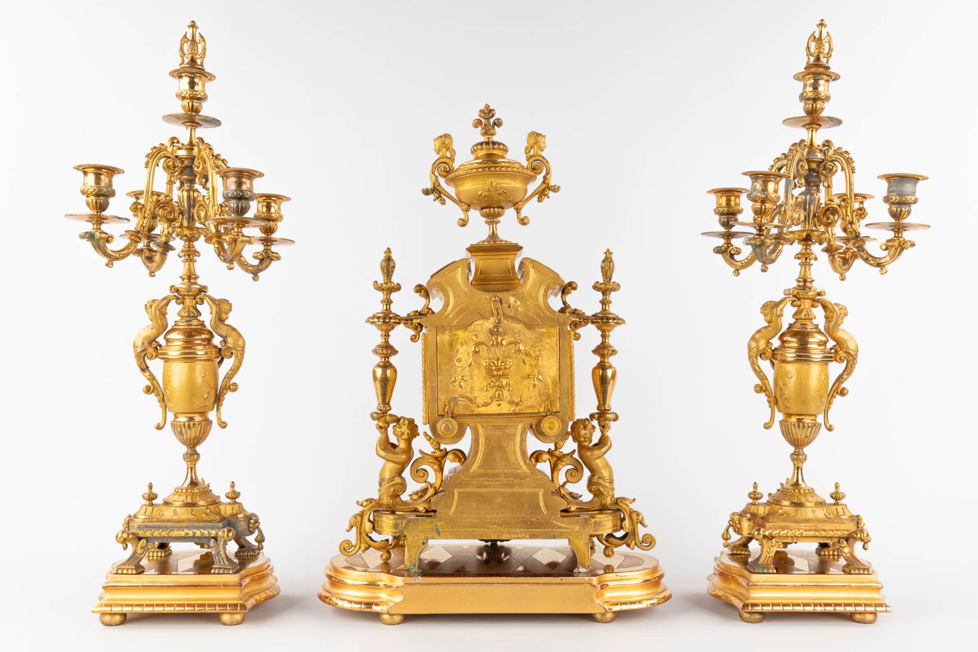A three-piece mantle garniture clock and candelabra, gilt spelter, decorated with putti. Circa 1900. - Image 5 of 19