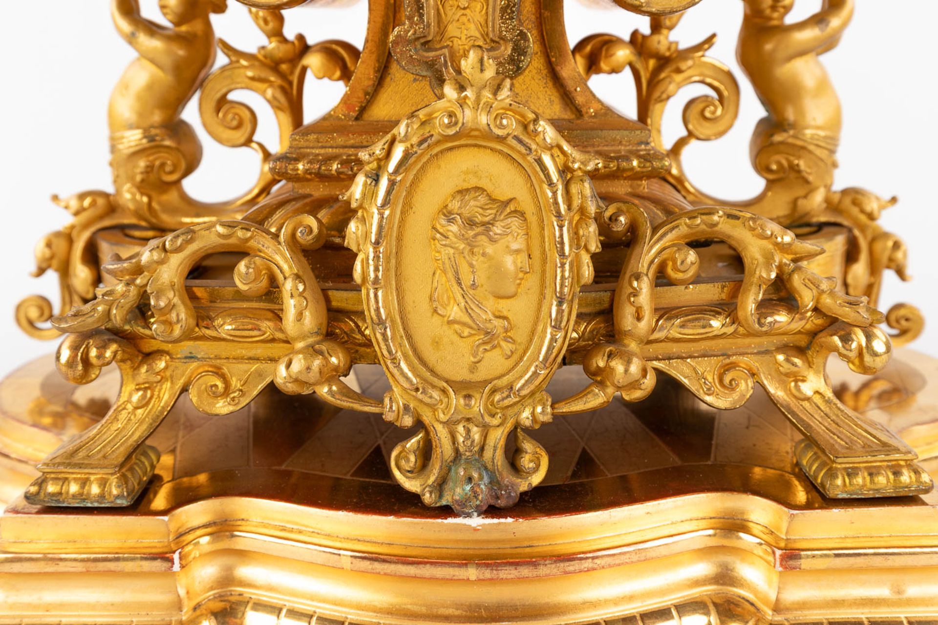 A three-piece mantle garniture clock and candelabra, gilt spelter, decorated with putti. Circa 1900. - Image 16 of 19