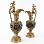 A pair of pitchers, patinated and gilt bronze. Decor of Putti and Angels. 20th C. (D:17 x W:25 x H:5