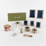 A collection of silver picture frames, added accessories by Christofle.
