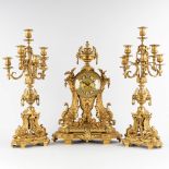 A three-piece mantle garniture clock and candelabra, gilt bronze in a Louis XVI style, 19th C. (D:19