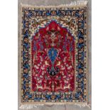 An Oriental hand-made carpet, decorated with fauna an florla. Wool and slik. (D:105 x W:74 cm)