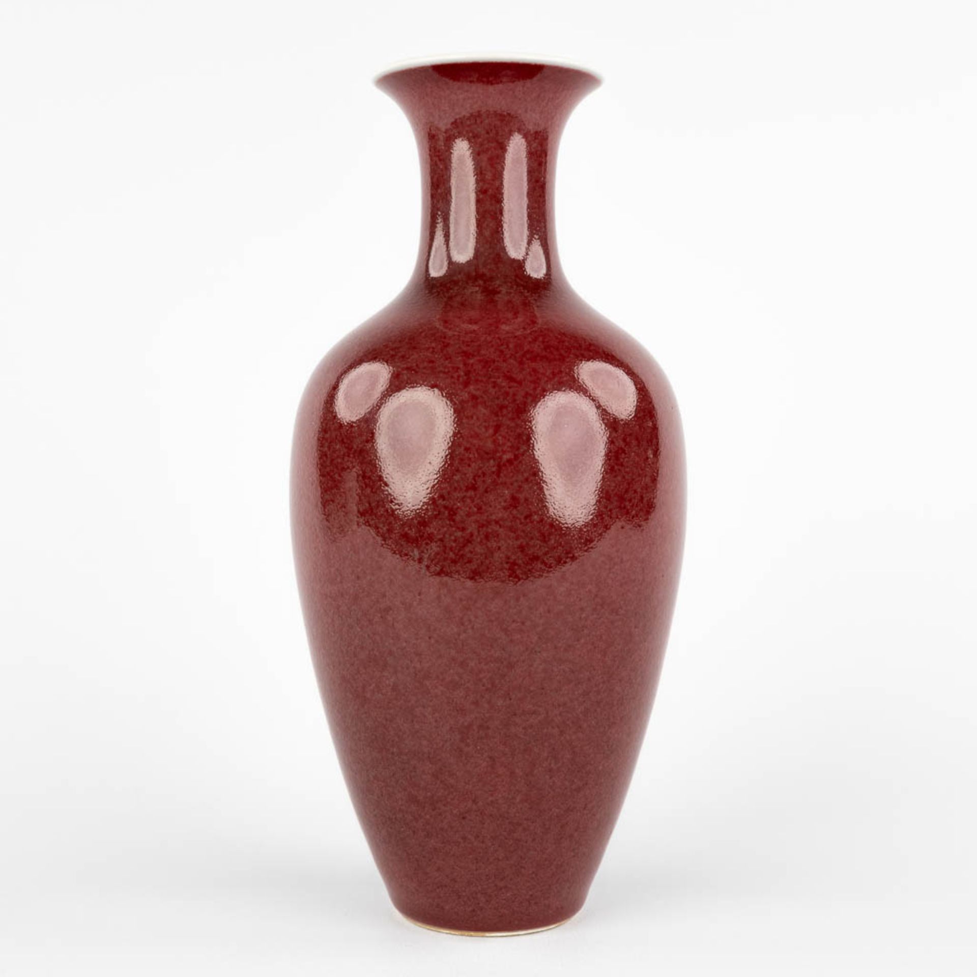 A Chinese 'Sang De Boeuf' vase with dark red glaze, Qianlong mark and period. (H:24 x D:11 cm)