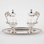 A pair of water and wine cruets, silver and glass. France, 19th/20th C. (D:15 x W:26 x H:15,5 cm)