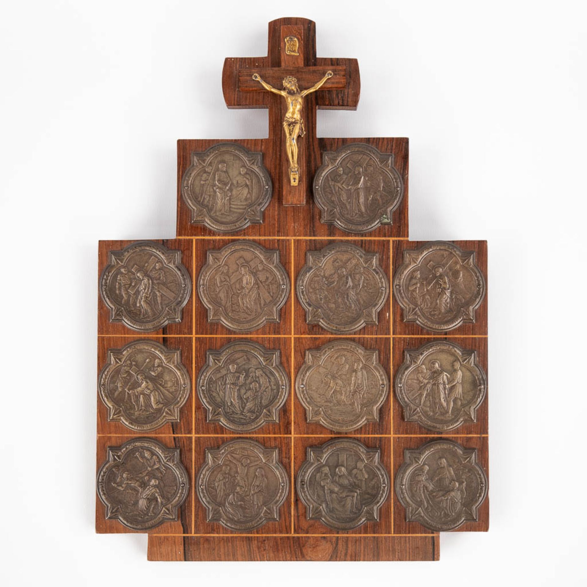 A wall plaque with 14 'Stations of the cross', medals and a crucifix. (W:22 x H:30 cm)