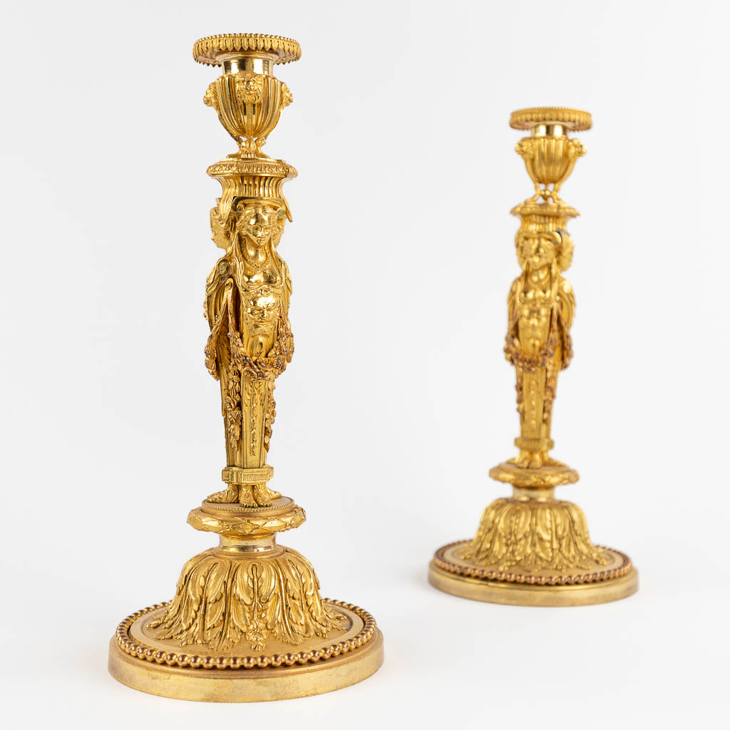 A pair of candlesticks/candleholders with Caryatids, gilt bronze in Louis XVI style. (H:33 x D:15 cm