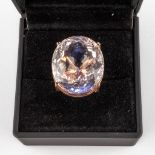 A ring, rose gold with a large facetted natural stone, 'Moranite' appr. 60ct. 21,29g. (D:2,7 x W:2,2