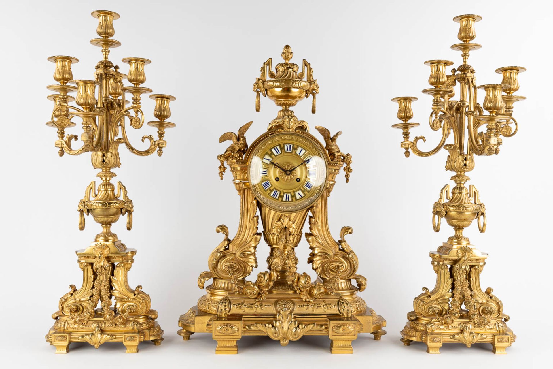 A three-piece mantle garniture clock and candelabra, gilt bronze in a Louis XVI style, 19th C. (D:19 - Image 3 of 19