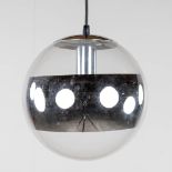 A ceiling lamp with glass shade and mirrored ring.