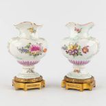 A pair of vases, polychrome porcelain with a hand-painted decor, mounted on a bronze base. 19th C. (