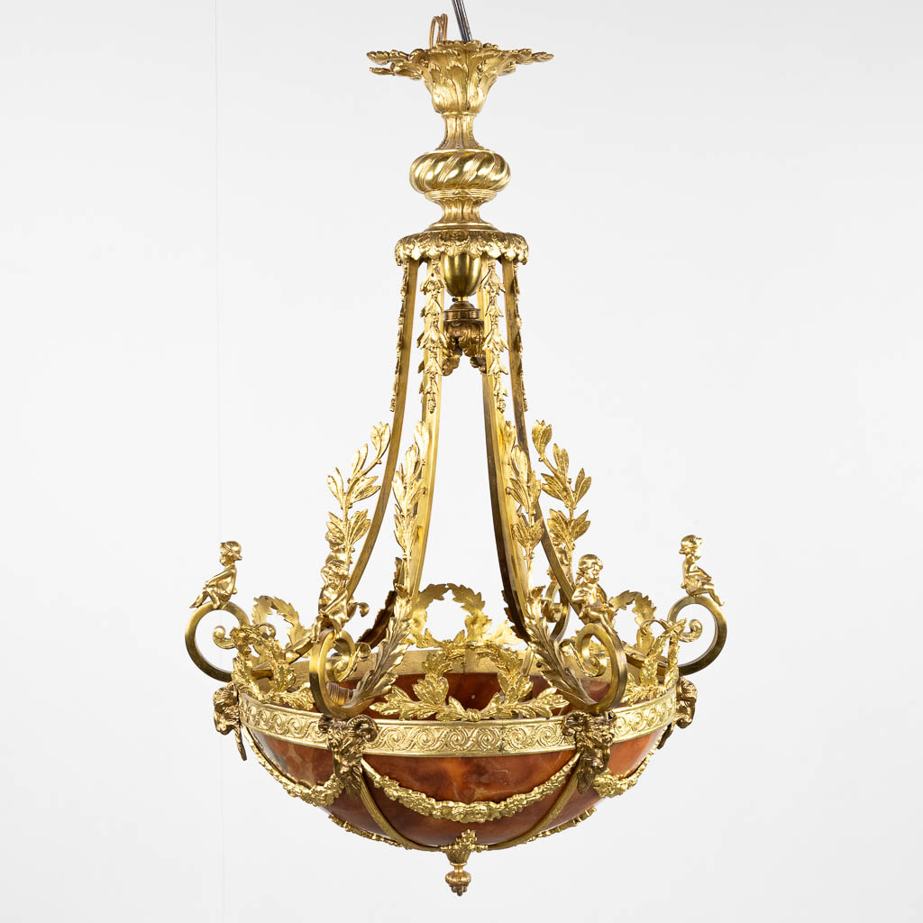 A chandelier, bronze with alabaster, decorated with putti and ram's heads, Louis XVI style. Circa 19