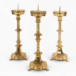 Three Chruch candlesticks, bronze in gothic revival style and standing on claw feet. (H:61 x D:20 cm