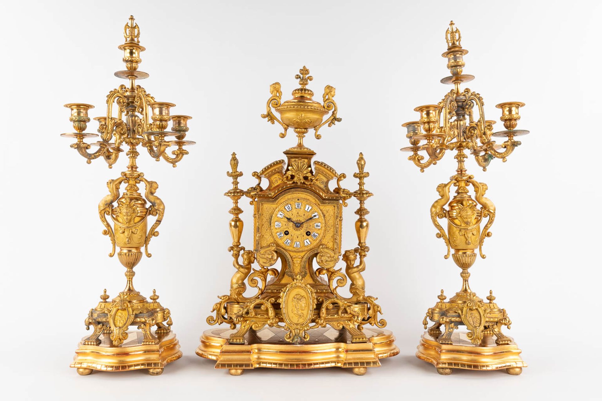 A three-piece mantle garniture clock and candelabra, gilt spelter, decorated with putti. Circa 1900. - Image 3 of 19