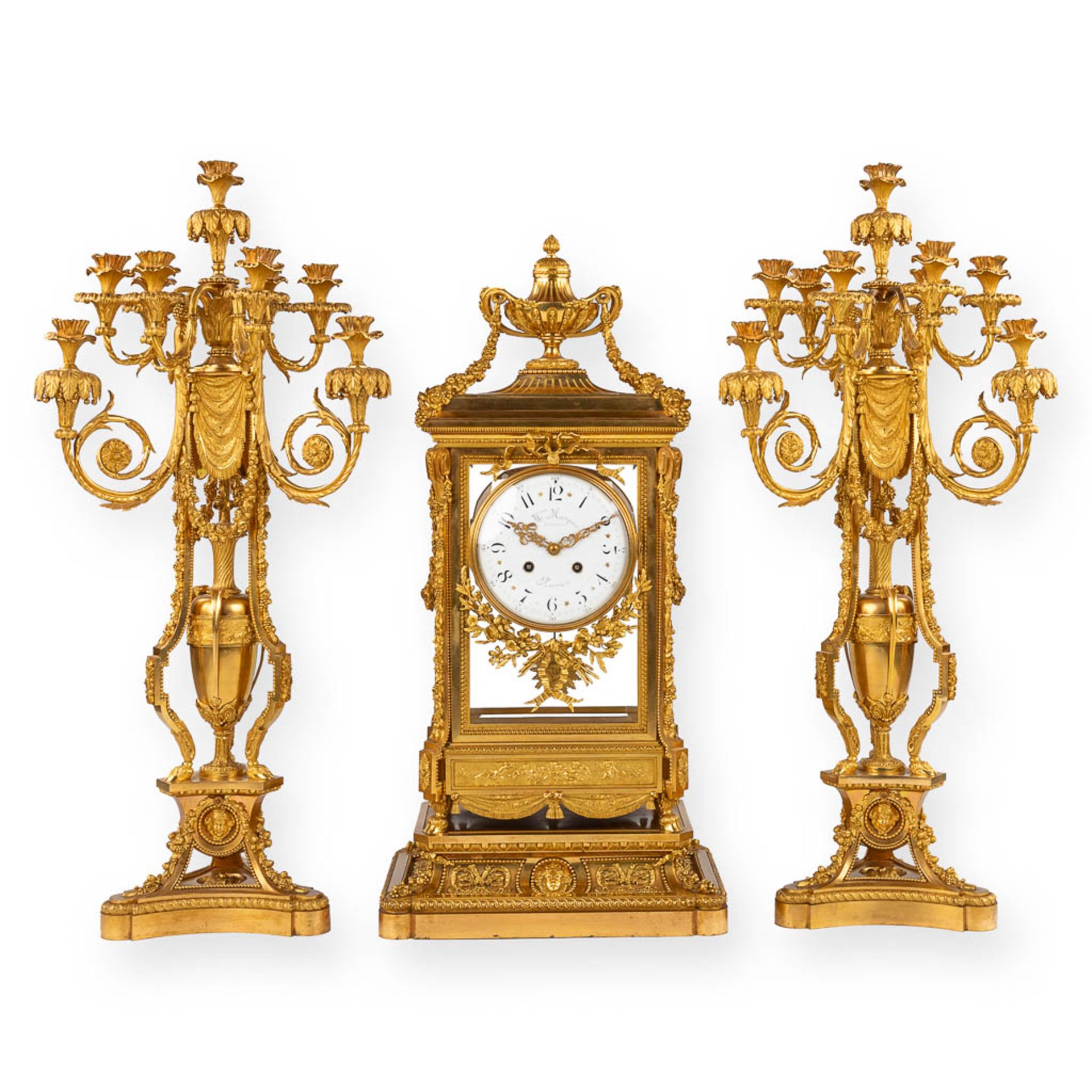 An imposing three-piece mantle garniture clock and candelabra, gilt bronze in Louis XVI style. Maiso