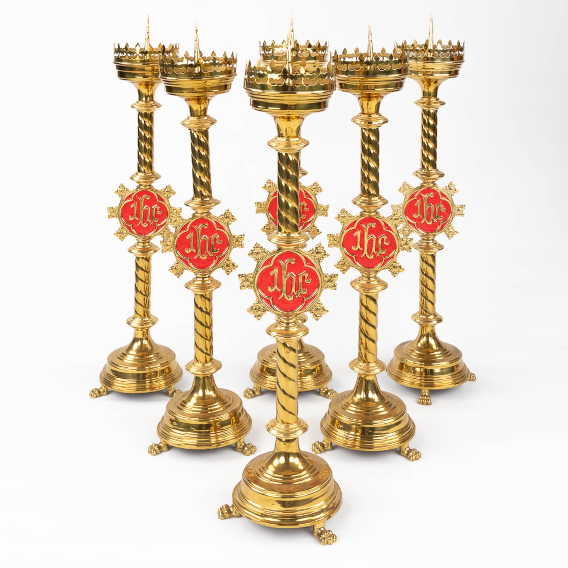 A set of 6 Church candlesticks with red IHS logo. (H:80 x D:20 cm)