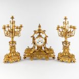 A three-piece mantle garniture clock and candelabra, gilt bronze in Louis XVI style. 19th C. (D:17 x