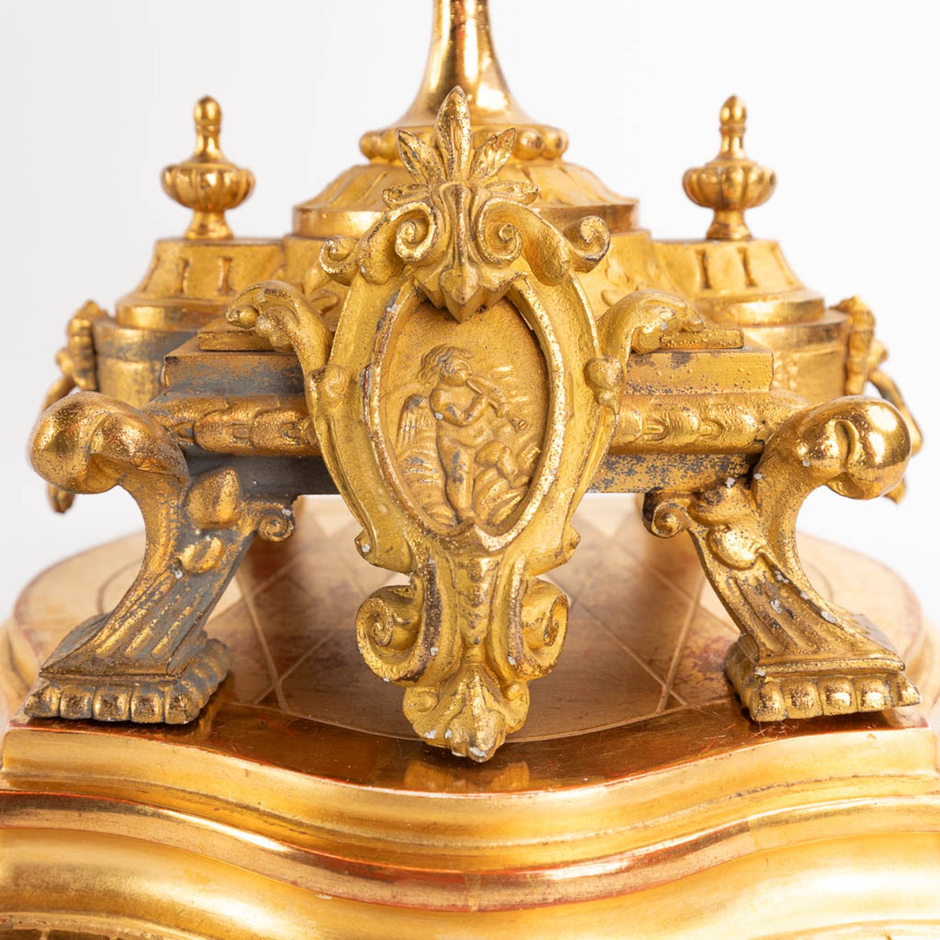 A three-piece mantle garniture clock and candelabra, gilt spelter, decorated with putti. Circa 1900. - Image 12 of 19