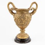 An urn with large handles, decorated with putti and grape vines, bronze mounted on marble. (W:25 x H