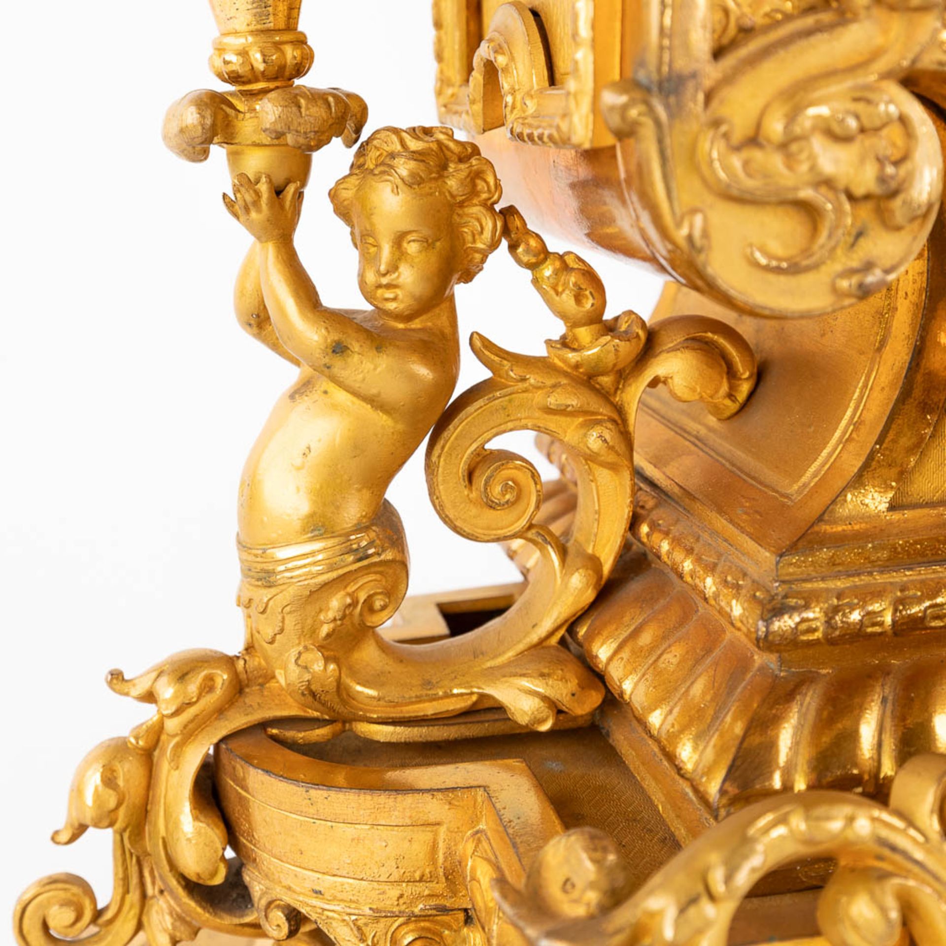 A three-piece mantle garniture clock and candelabra, gilt spelter, decorated with putti. Circa 1900. - Image 18 of 19
