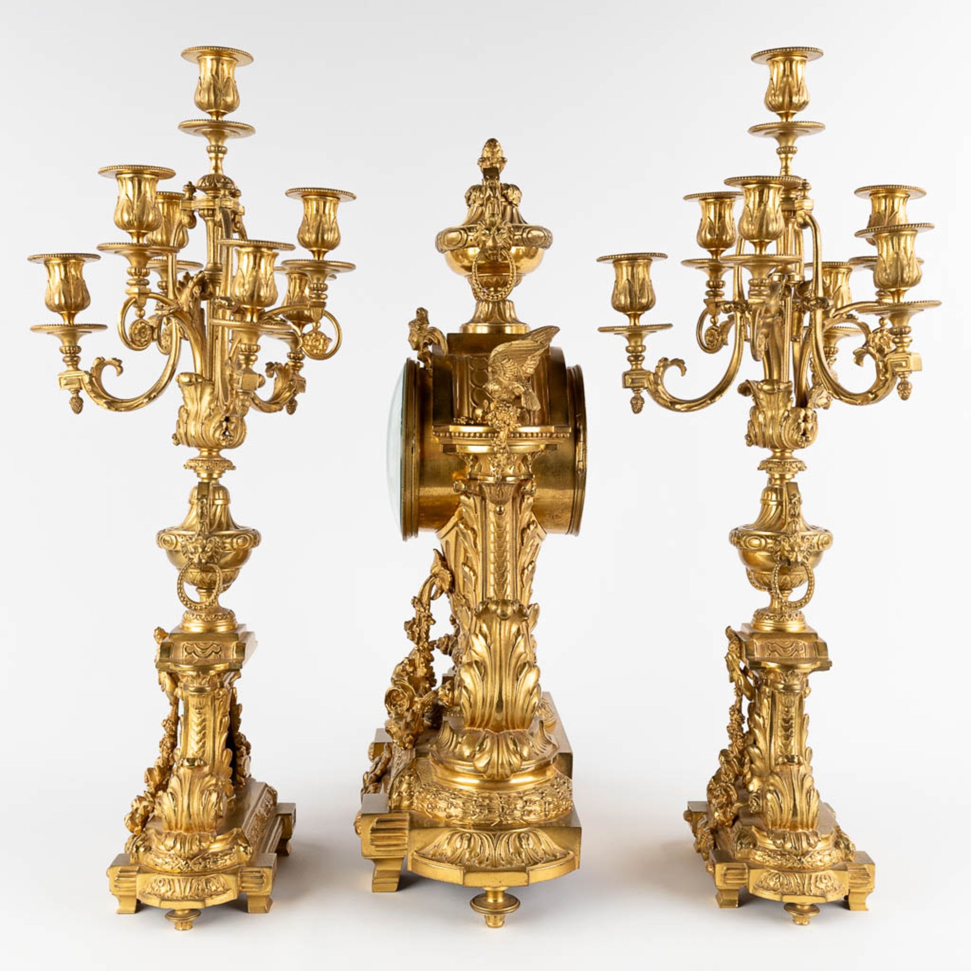 A three-piece mantle garniture clock and candelabra, gilt bronze in a Louis XVI style, 19th C. (D:19 - Image 8 of 19