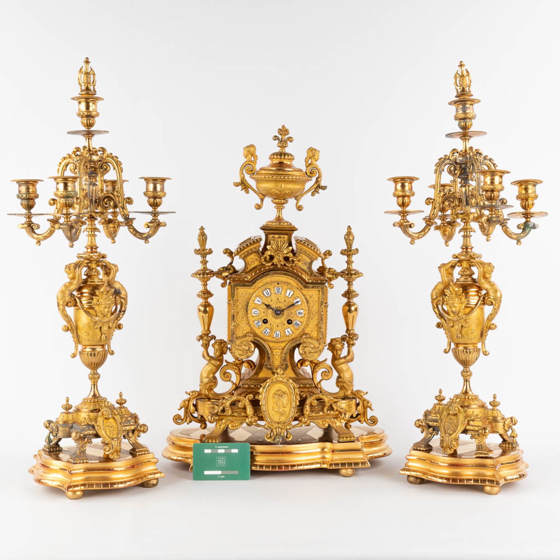 A three-piece mantle garniture clock and candelabra, gilt spelter, decorated with putti. Circa 1900. - Image 2 of 19