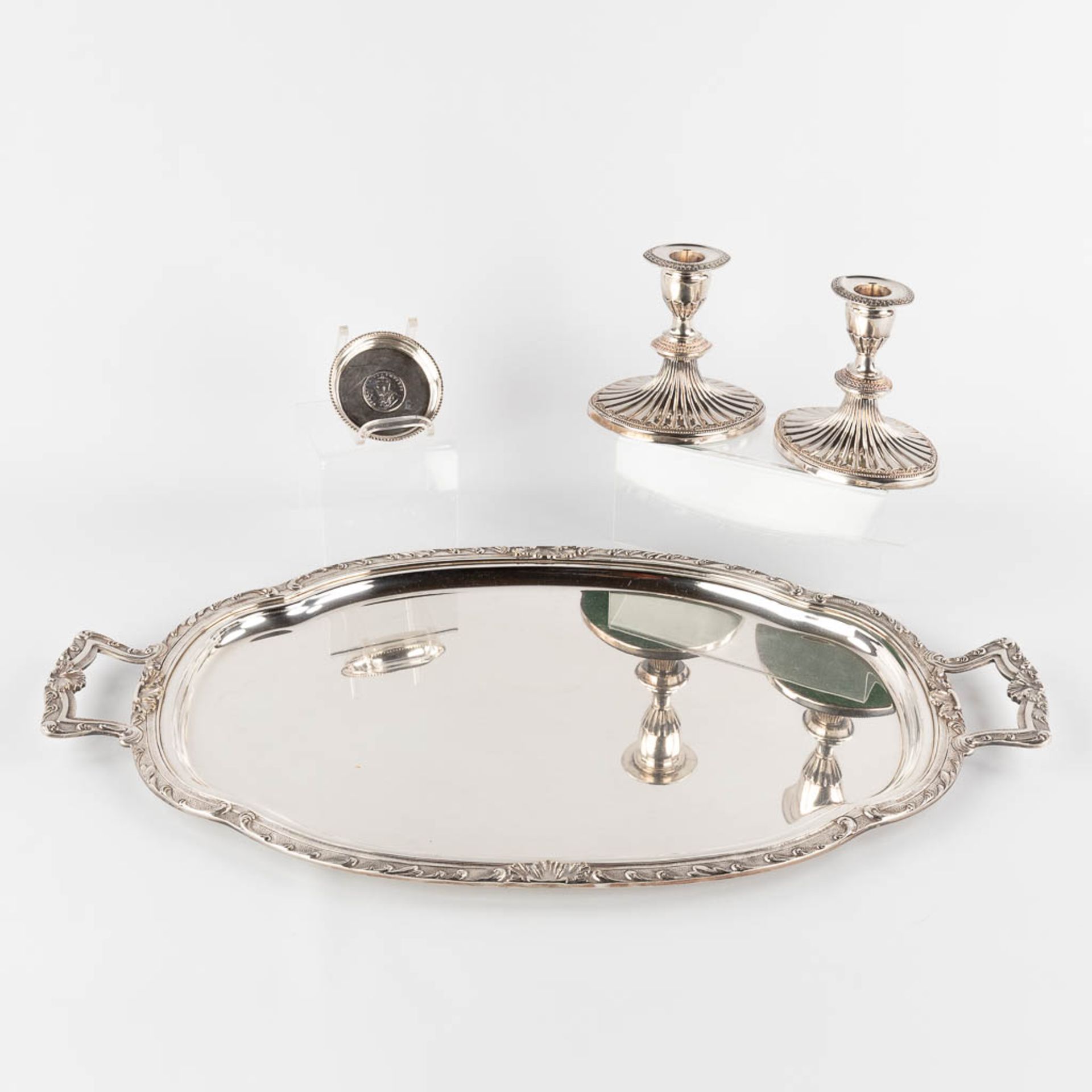 A silver-plated serving tray, two candlesticks and a bowl with Silver coin, One Rupee 1918. (D:37 x