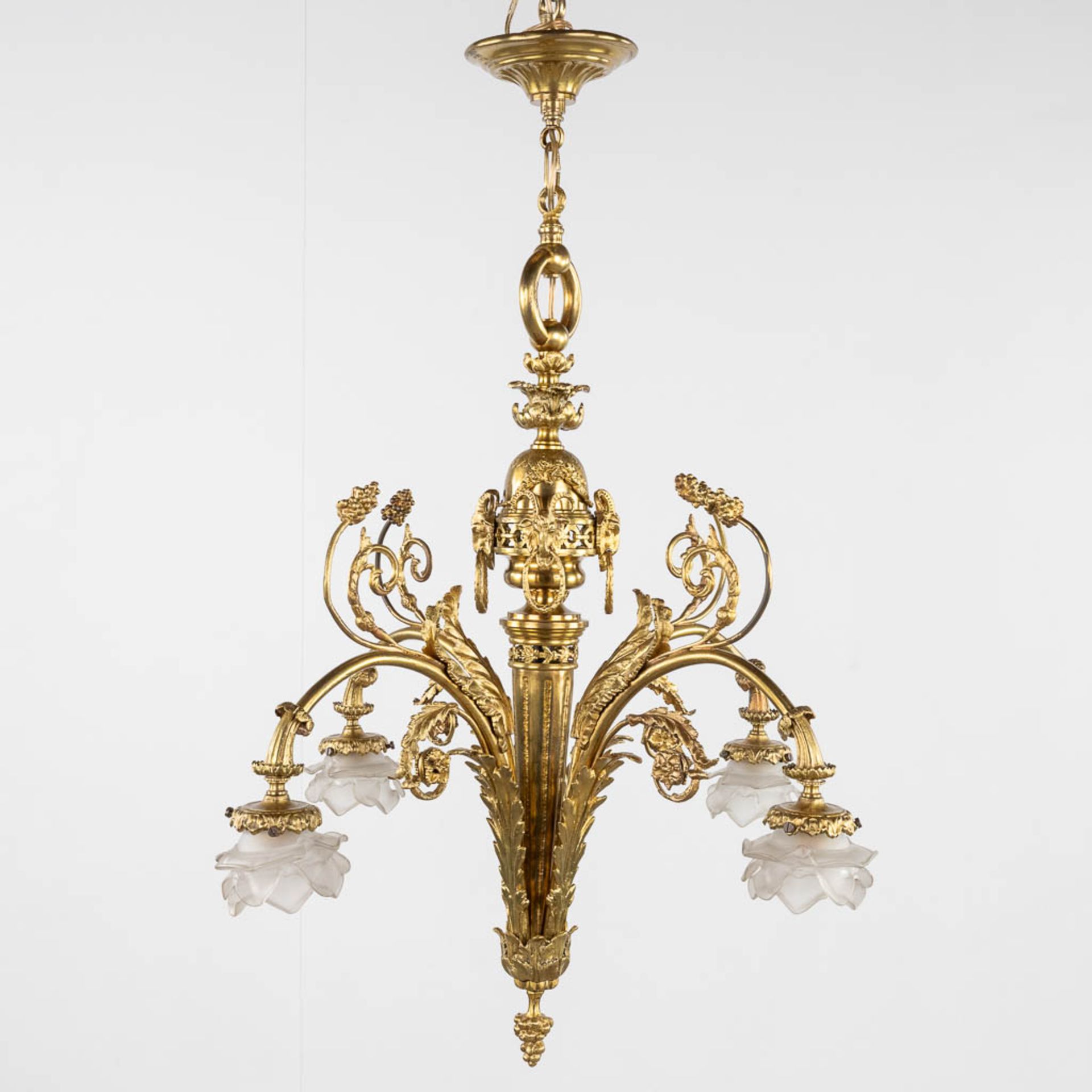 A chandelier, bronze finished with ram's heads, Louis XVI style. (H:93 x D:66 cm)
