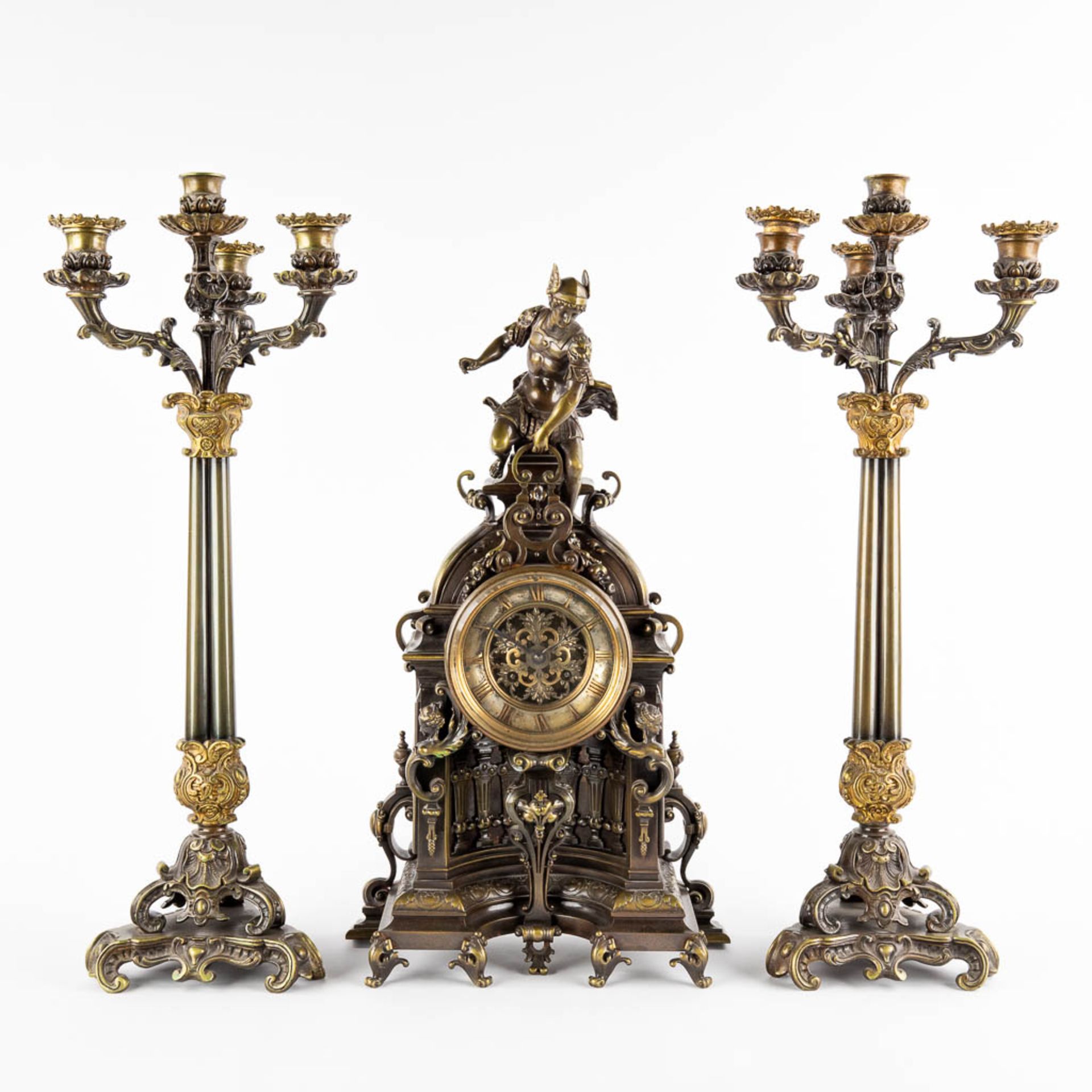A three-piece mantle garniture clock and candelabra. Clock with an image of Mercury/Hermès. 19th C.