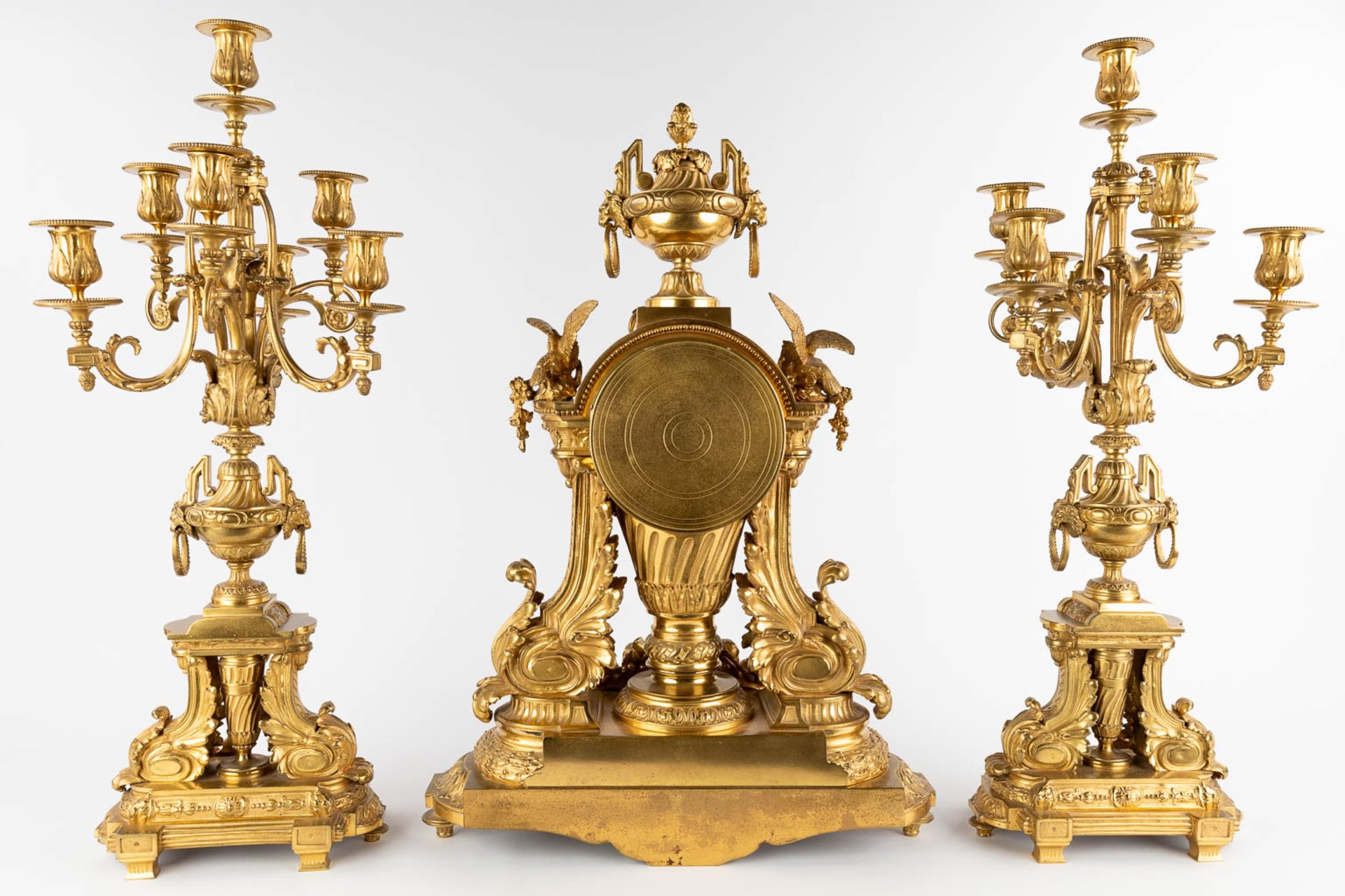 A three-piece mantle garniture clock and candelabra, gilt bronze in a Louis XVI style, 19th C. (D:19 - Image 5 of 19