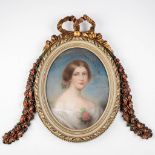 An antique frame with a portrait, wood sculptured in Louis XVI style. Portrait of a lady, gouache on