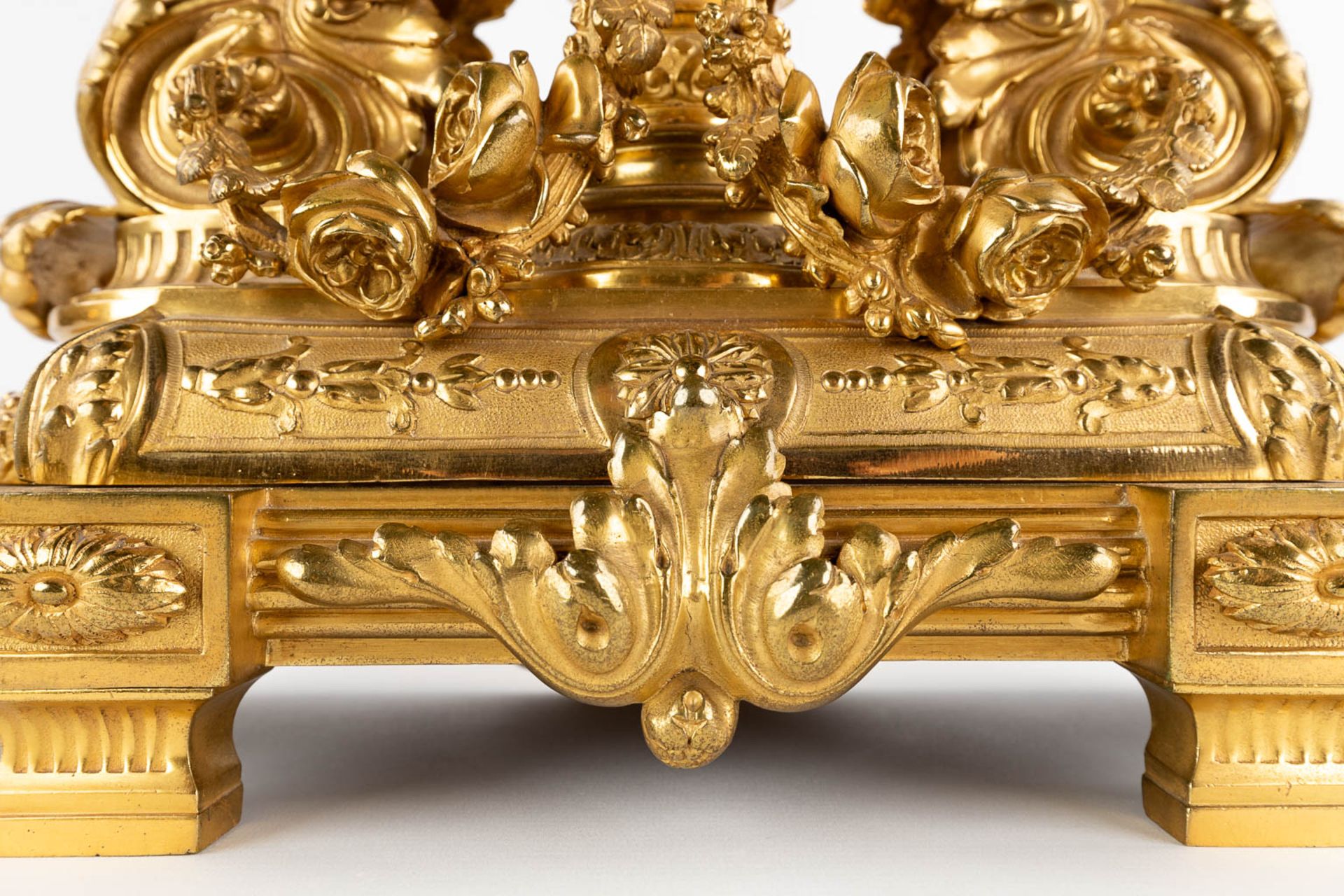 A three-piece mantle garniture clock and candelabra, gilt bronze in a Louis XVI style, 19th C. (D:19 - Image 19 of 19