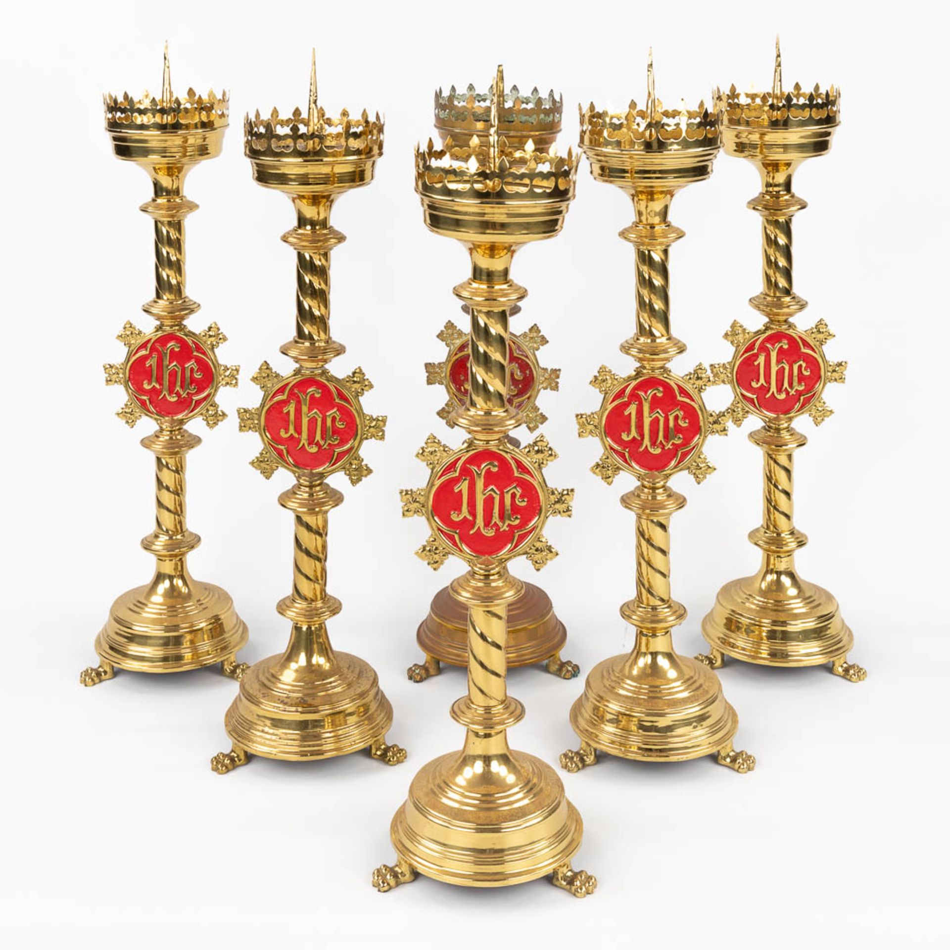 A set of 6 Church candlesticks with red IHS logo. (H:72 x D:20 cm)