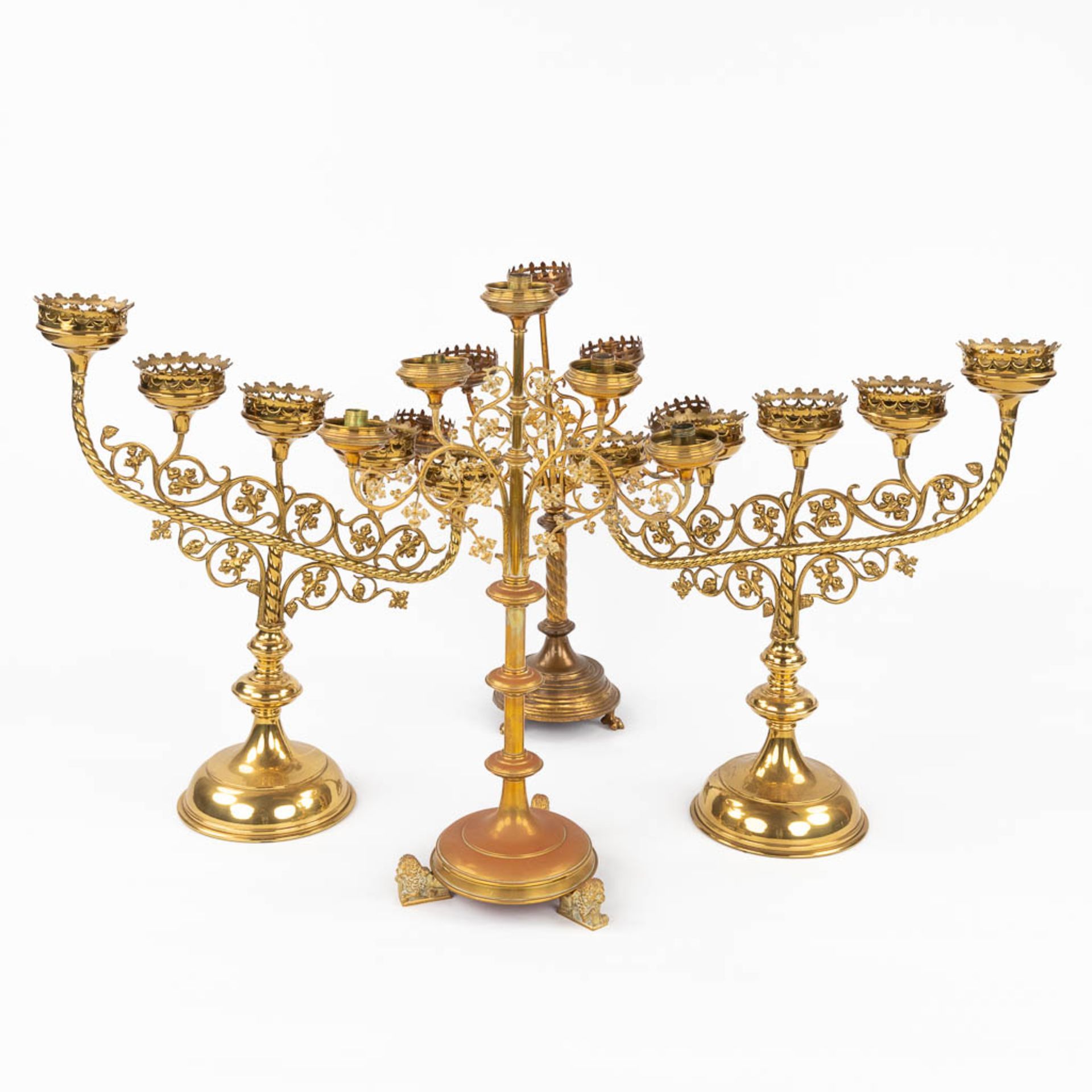 Four Church candlesticks, bronze in a gothic revival style. A pair and two singles. (D:18 x W:51 x H