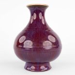 A Chinese vase with monochrome blue/purple glaze. 19th C. (H:22 x D:17 cm)