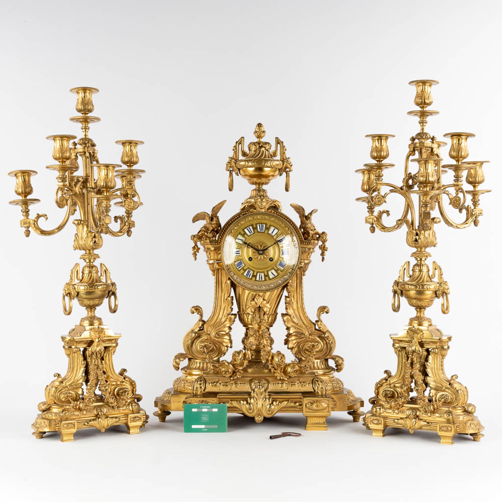 A three-piece mantle garniture clock and candelabra, gilt bronze in a Louis XVI style, 19th C. (D:19 - Image 2 of 19