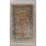 An Oriental hand-made silk carpet, Isfahan. (L:153 x W:92,5 cm)