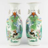 A pair of Chinese vases, decorated with playing children and kaligraphic texts. (H:59 x D:23 cm)