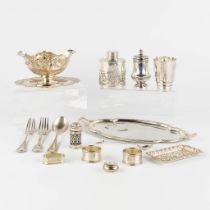 15 pieces of silver utensils and table accessories. Saucers, bowls, tea cannister, and more. 1131g.