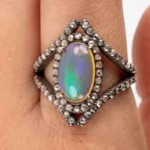 A ring with central opal stone and uncut diamonds, silver. 6,43g. Ring size 63.