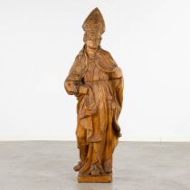 An antique wood-sculptured figurine of a Cardinal. 18th/19th C. (L:32 x W:44 x H:136 cm)