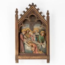 A large station of the cross in a gothic revival frame, 'The Descent From The Cross'. Polychrome pla